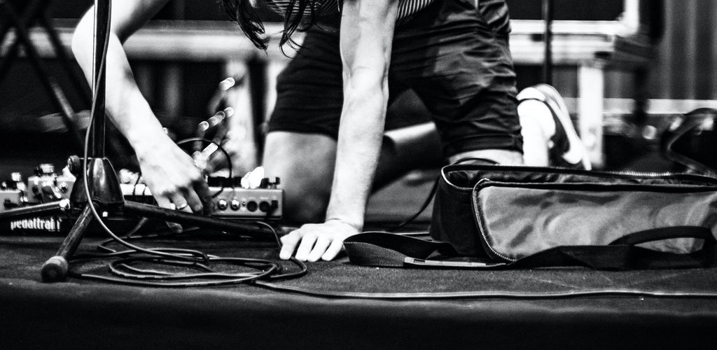 Guitarist setting up pedals