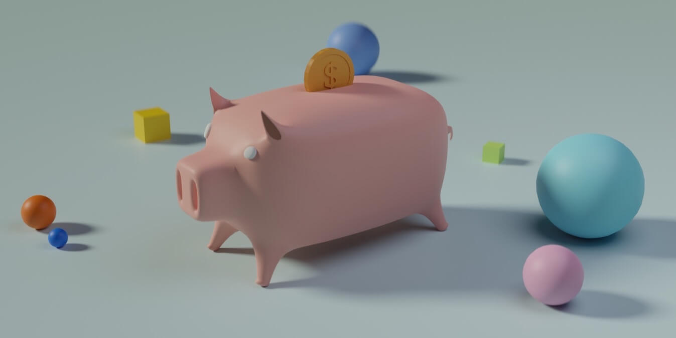A piggybank with balls and blocks near it.